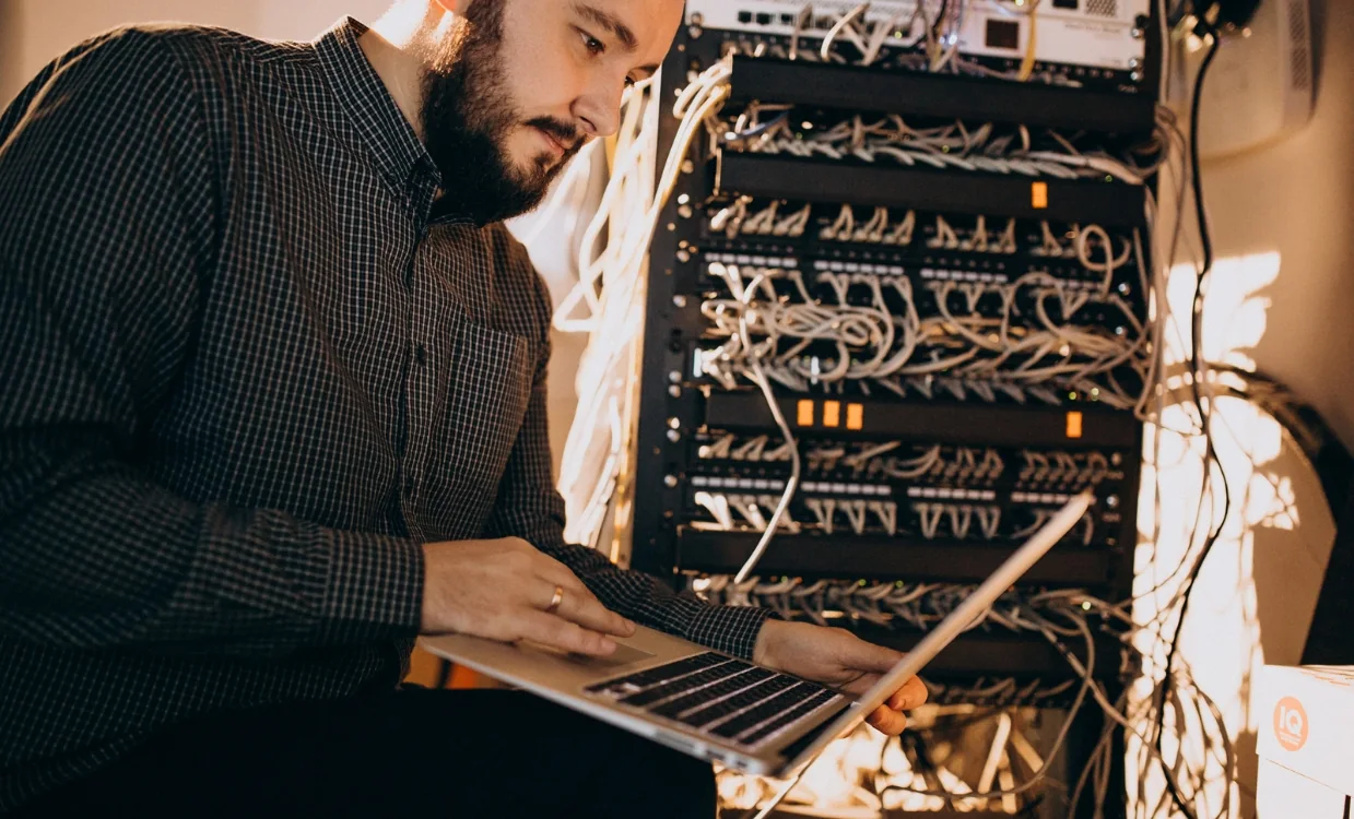 Engineer working at a cabled server rack during an infrastructure build